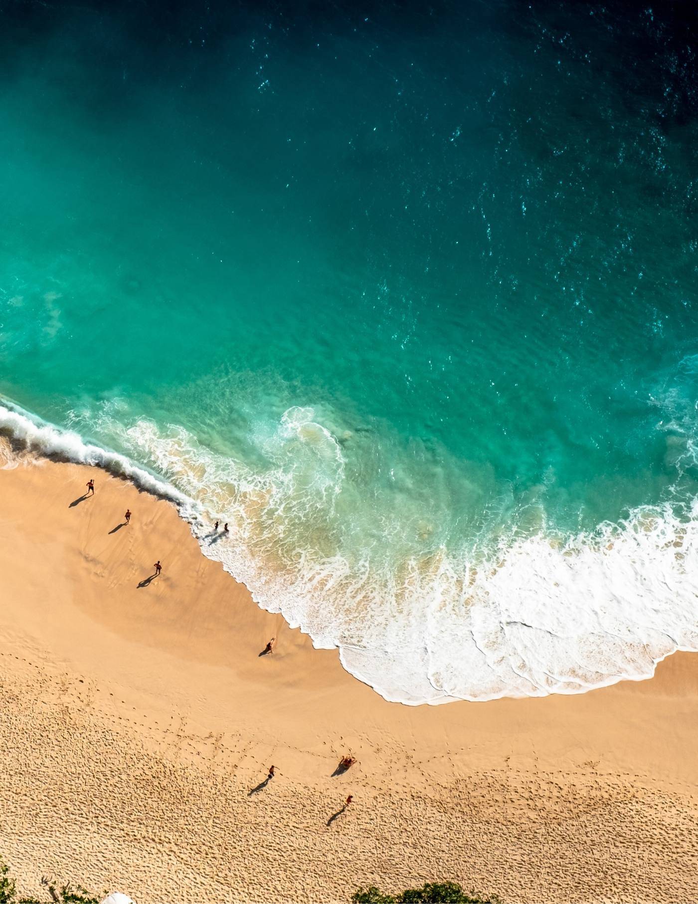 Aerial view of a sailboat in turquoise Caribbean waters