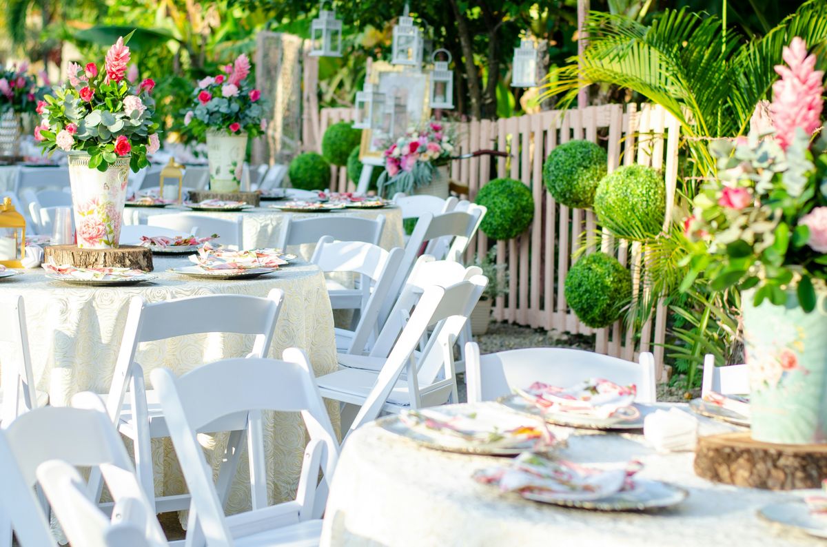 Outdoor wedding reception tablescape with floral centerpieces